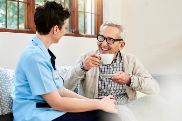 Shot of a nurse caring for a senior patient in a retirement home